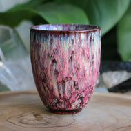 Handmade ceramic tea cup with pink reactive glaze and handleless
