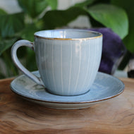 Handmade ceramic cup and saucer with blue white pinstripe glaze