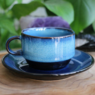 Handmade ceramic cup and saucer set with blue fade glaze