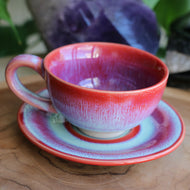 Handmade ceramic cup and saucer set with pink blue reactive glaze