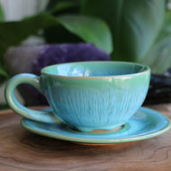 Handmade ceramic cup and saucer set with green and blue reactive glaze