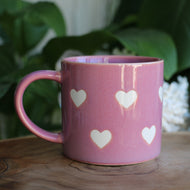 Pink handmade ceramic mug with white hearts