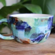 Large ceramic porcelain cup with ocean-like colouring and pattern.