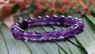 Handmade Amethyst 8mm crystal bracelet featuring natural purple gemstone beads on elastic stretch cord.